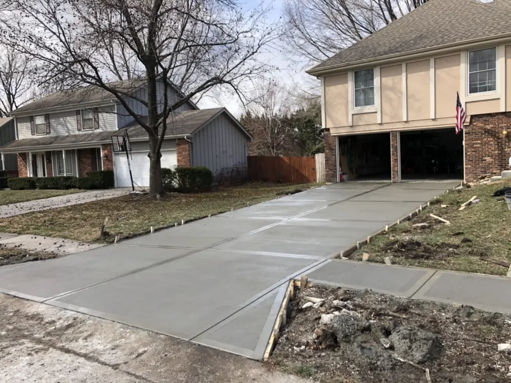 Freshly poured, still-wet concrete driveways being leveled — by Manawatu Concrete.