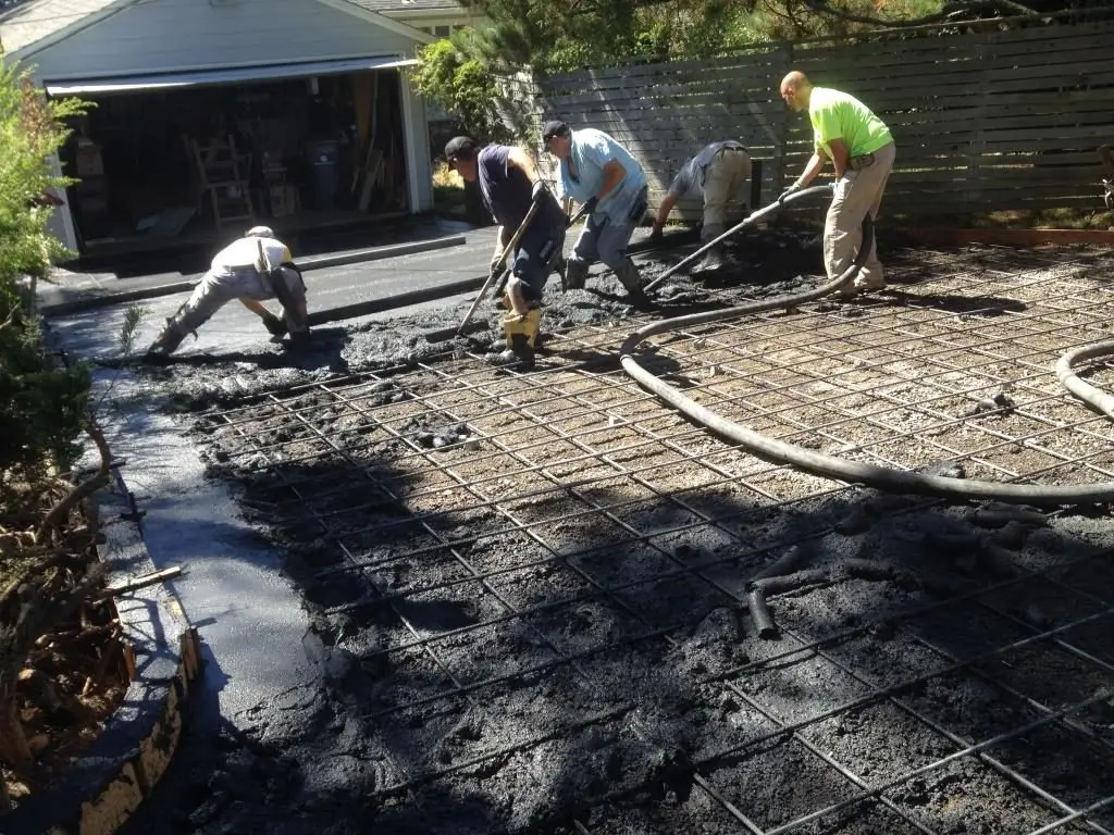 Construction of a concrete driveways in progress, with formwork and leveling underway — by Manawatu Concrete.