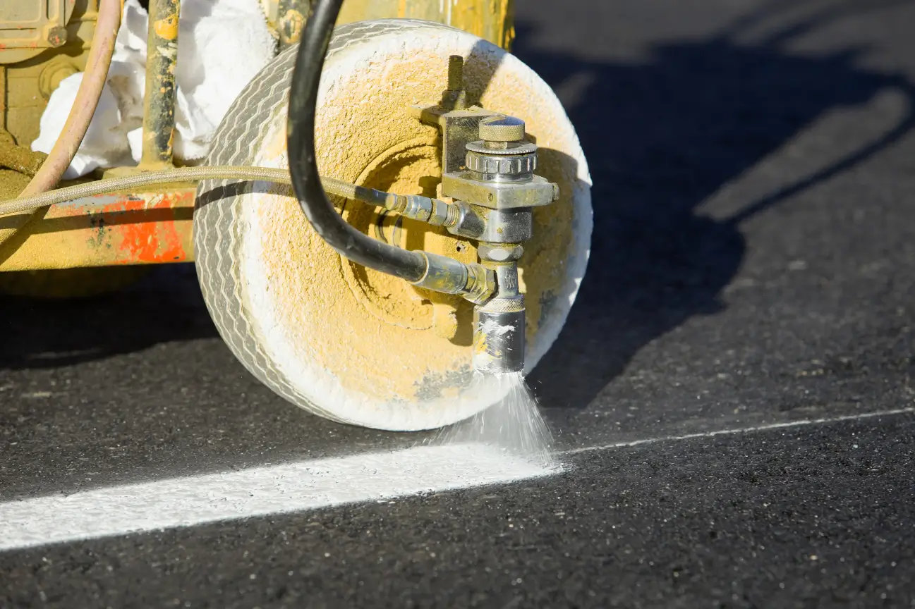 Machine painting clear lines during asphalt carpark construction by Asphalt Carpark Construction Wairarapa and Manawatu Concrete.