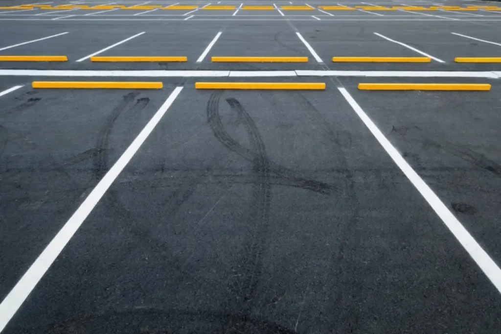 Outdoor asphalt carpark with yellow wheel stops completed by Asphalt Carpark Construction Wairarapa and Manawatu Concrete.
